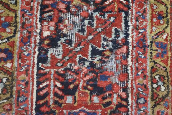 A Persian Heriz red ground carpet, 380 x 280cm, worn